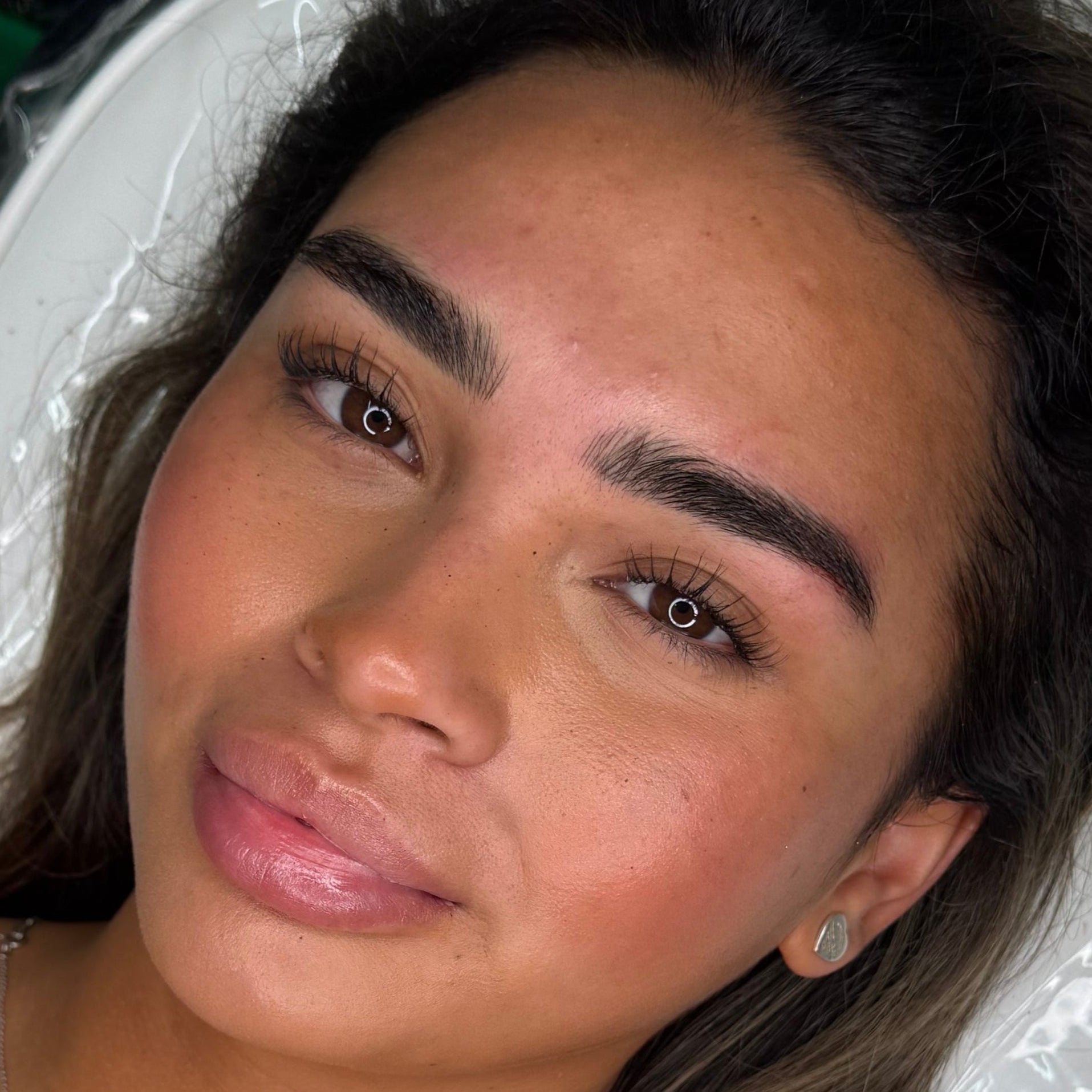 Woman with perfectly shaped brows after having microblading treatment