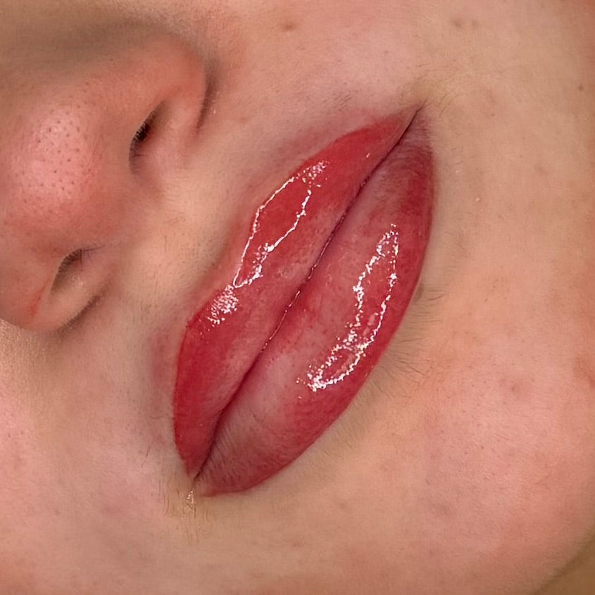 Close-up of a person's lips with glossy lipstick